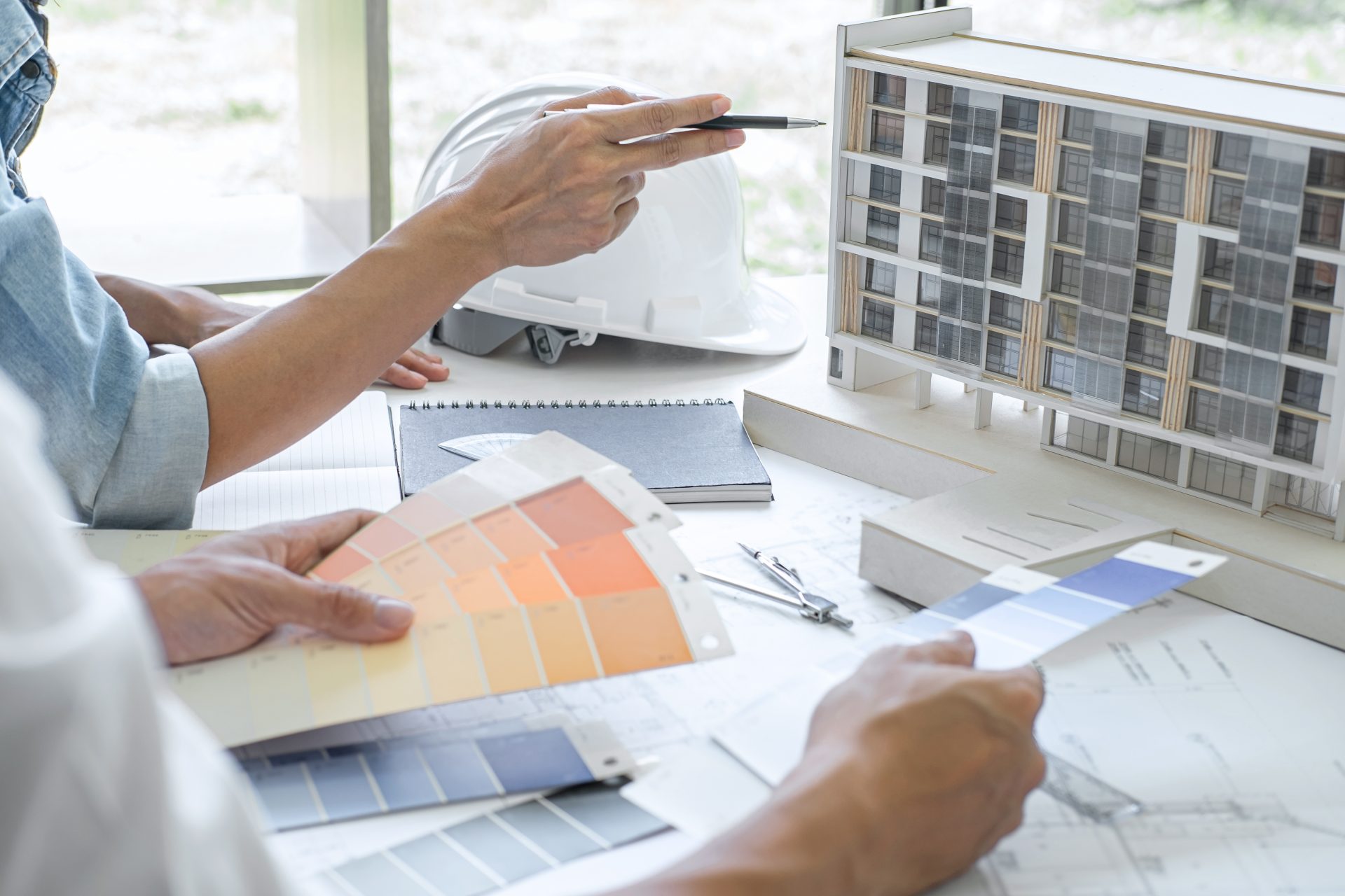 Construction and structure concept of Engineer or architect teamwork meeting for project working with partner and engineering tools on model building and blueprint in working site.