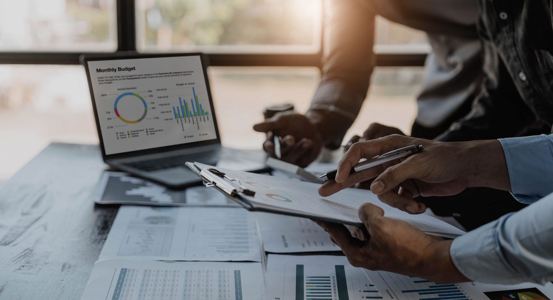 Business People Meeting using laptop computer,calculator,notebook,stock market chart paper for analysis Plans to improve quality next month. Conference Discussion Corporate Concept